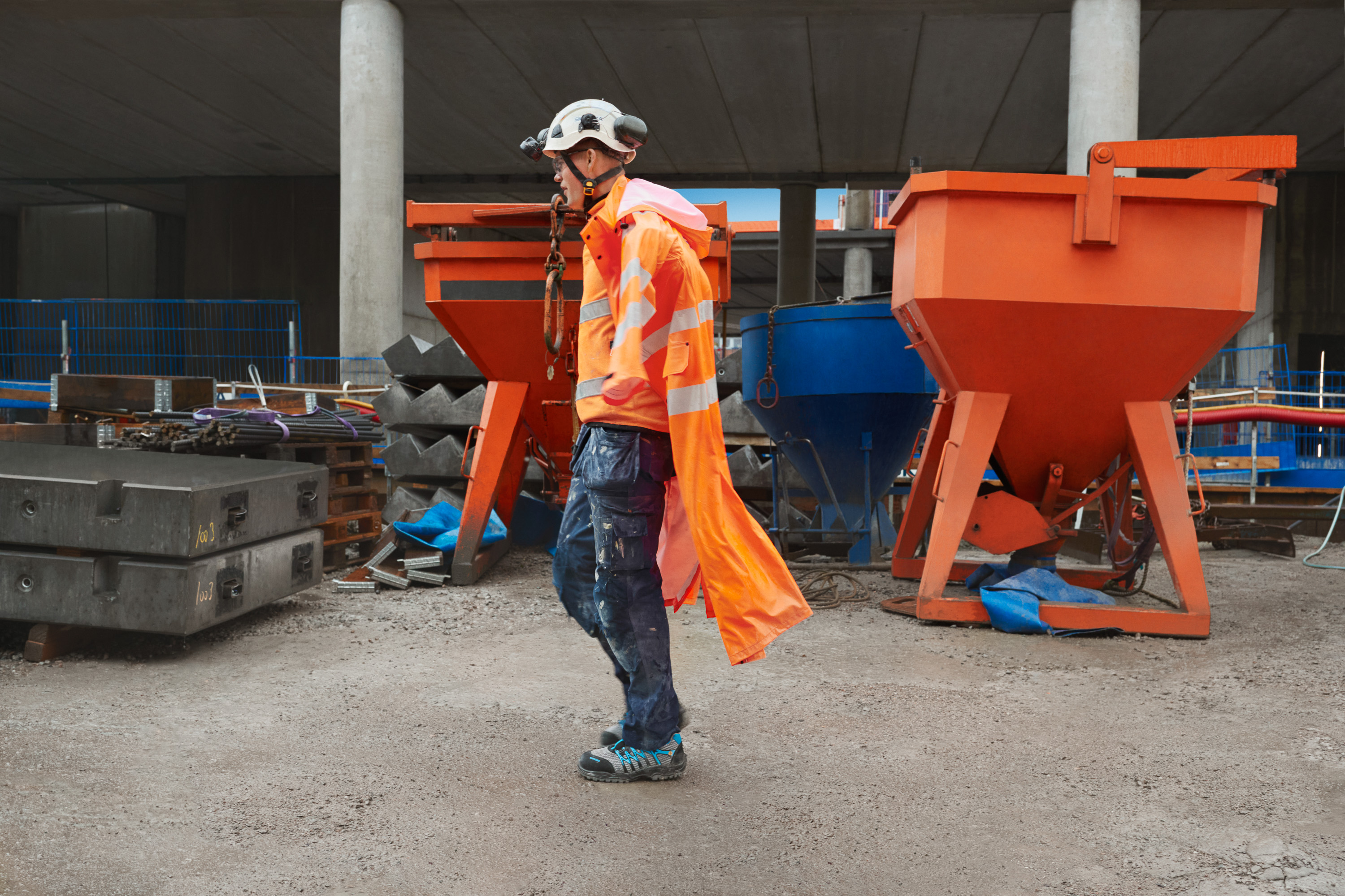 Construction worker with helmet walks on a construction site